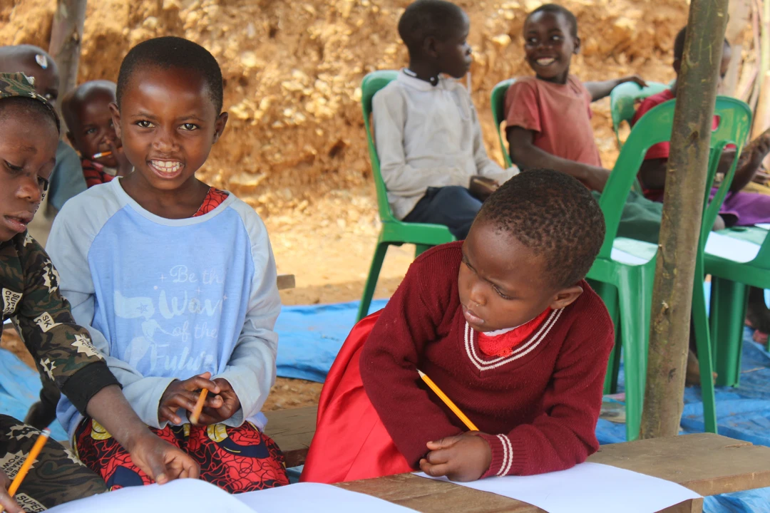 kid writing on a banana leaf